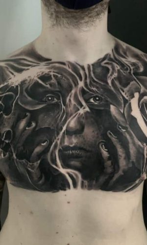 Skull, roses and woman portrait tattoo in black and grey realism on chest, London, UK